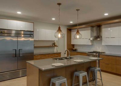 Cabinets and Kitchen with island and ceiling lights-Kamloops Kitchen Studio
