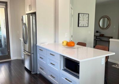 White kitchen next to family room-Kamloops Kitchen Studio